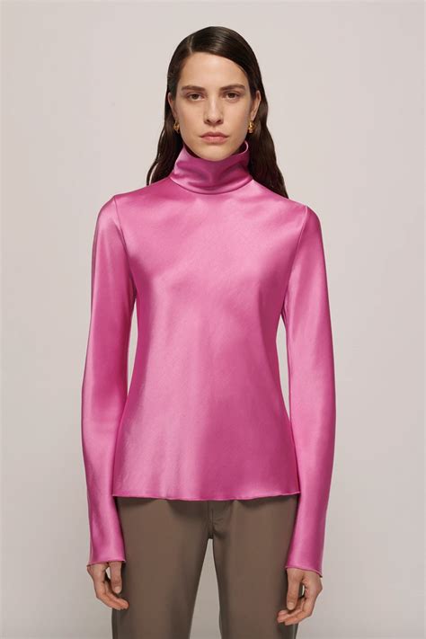 Loose silk turtleneck with shirt cuffs .